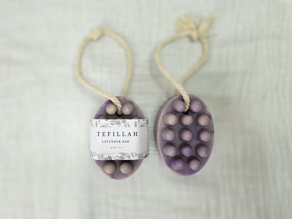 Close-up of Tefillah lavender soap on a rope showing natural texture, made with olive oil, shea butter and lavender fragrance oil
