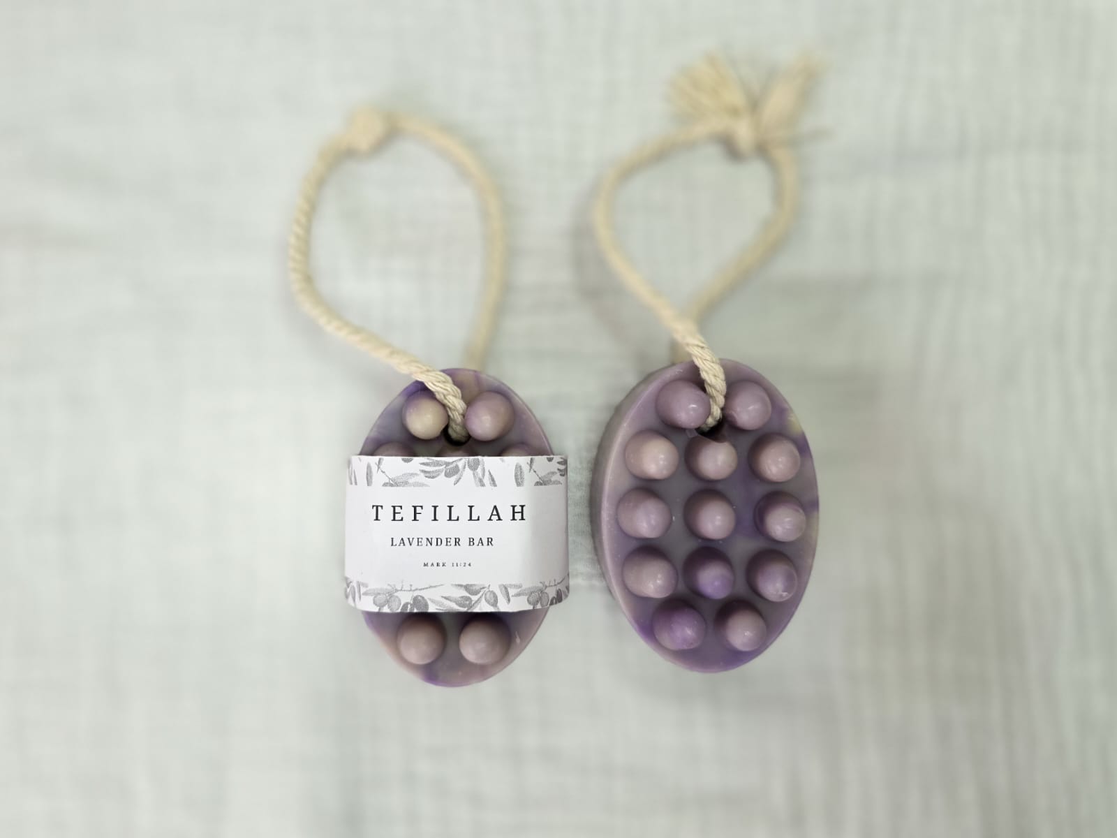 Close-up of Tefillah lavender soap on a rope showing natural texture, made with olive oil, shea butter and lavender fragrance oil