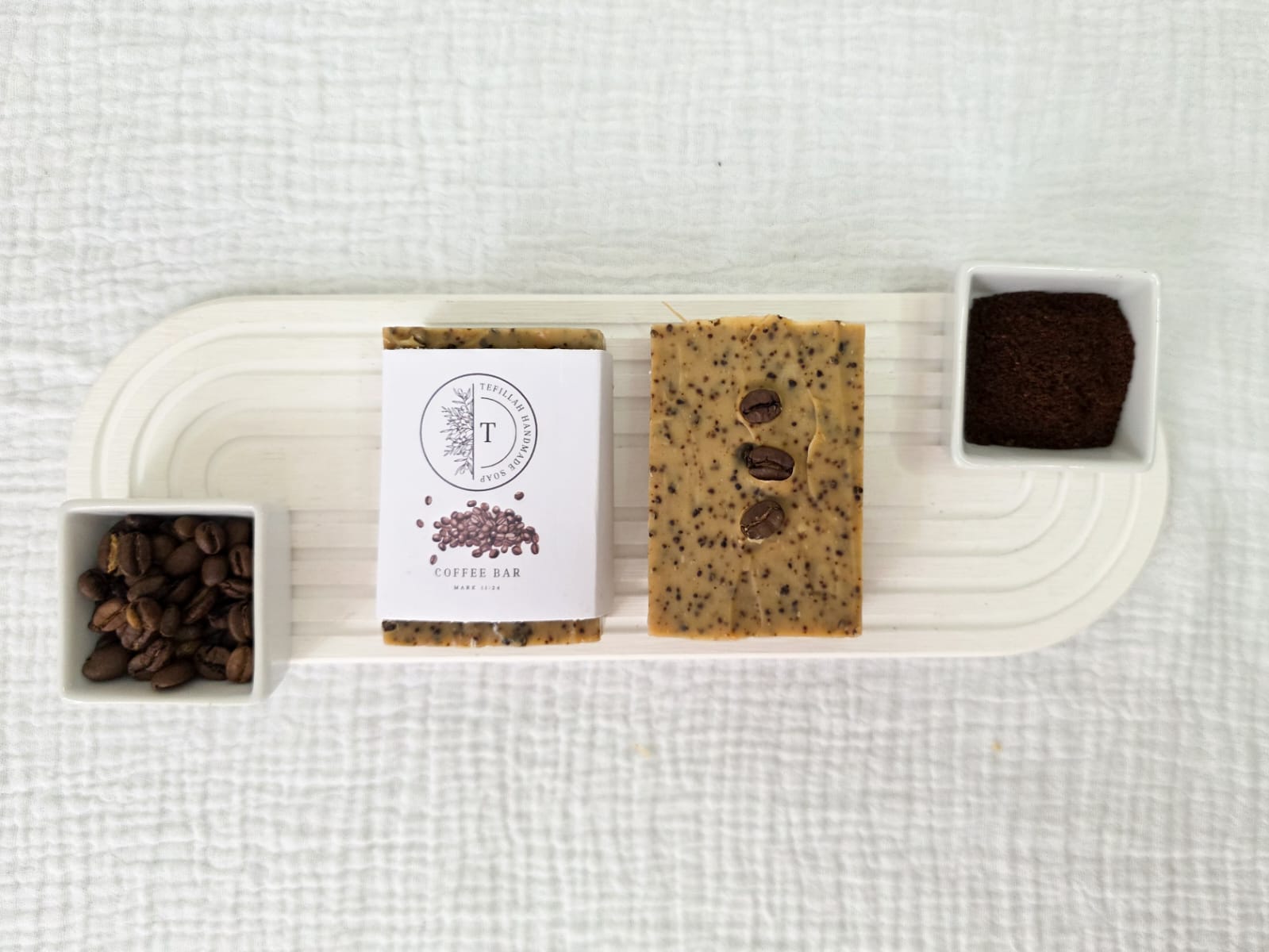 Close-up of Tefillah coffee soap bar showing coffee ground texture, made with filter coffee, coffee grounds and shea butter