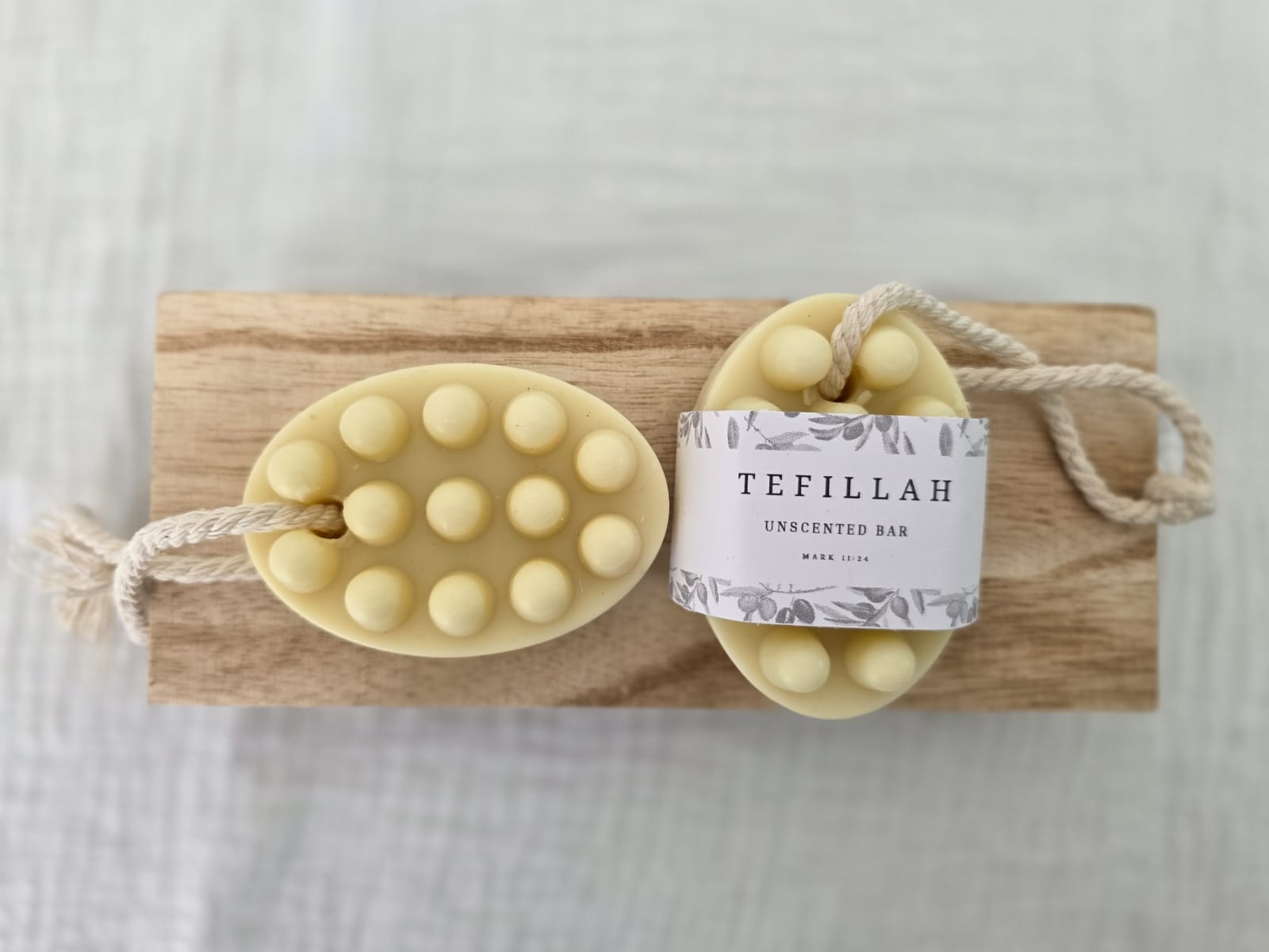 Close-up of Tefillah handmade unscented soap on a rope showing natural texture, made with olive oil and shea butter