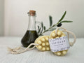 Handmade unscented soap on a rope hanging in a shower, gentle for sensitive and eczema-prone skin