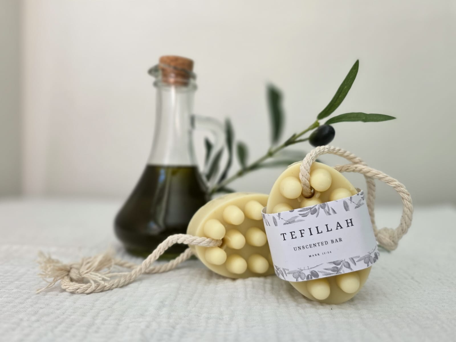 Handmade unscented soap on a rope hanging in a shower, gentle for sensitive and eczema-prone skin