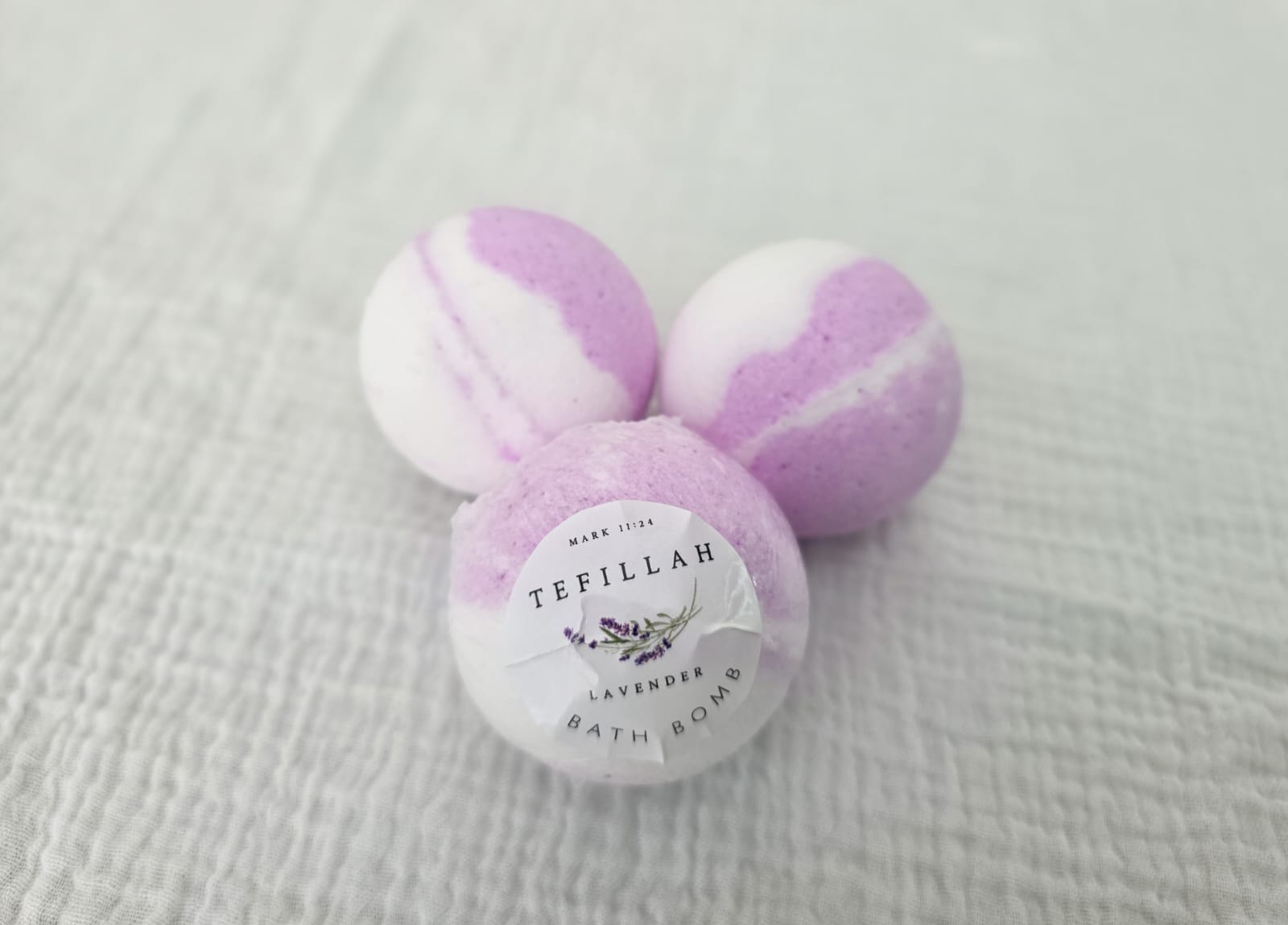 Handmade lavender bath bomb by Tefillah Handmade Products, infused with coconut oil and lavender essential oil for a calming, spa-like bath experience